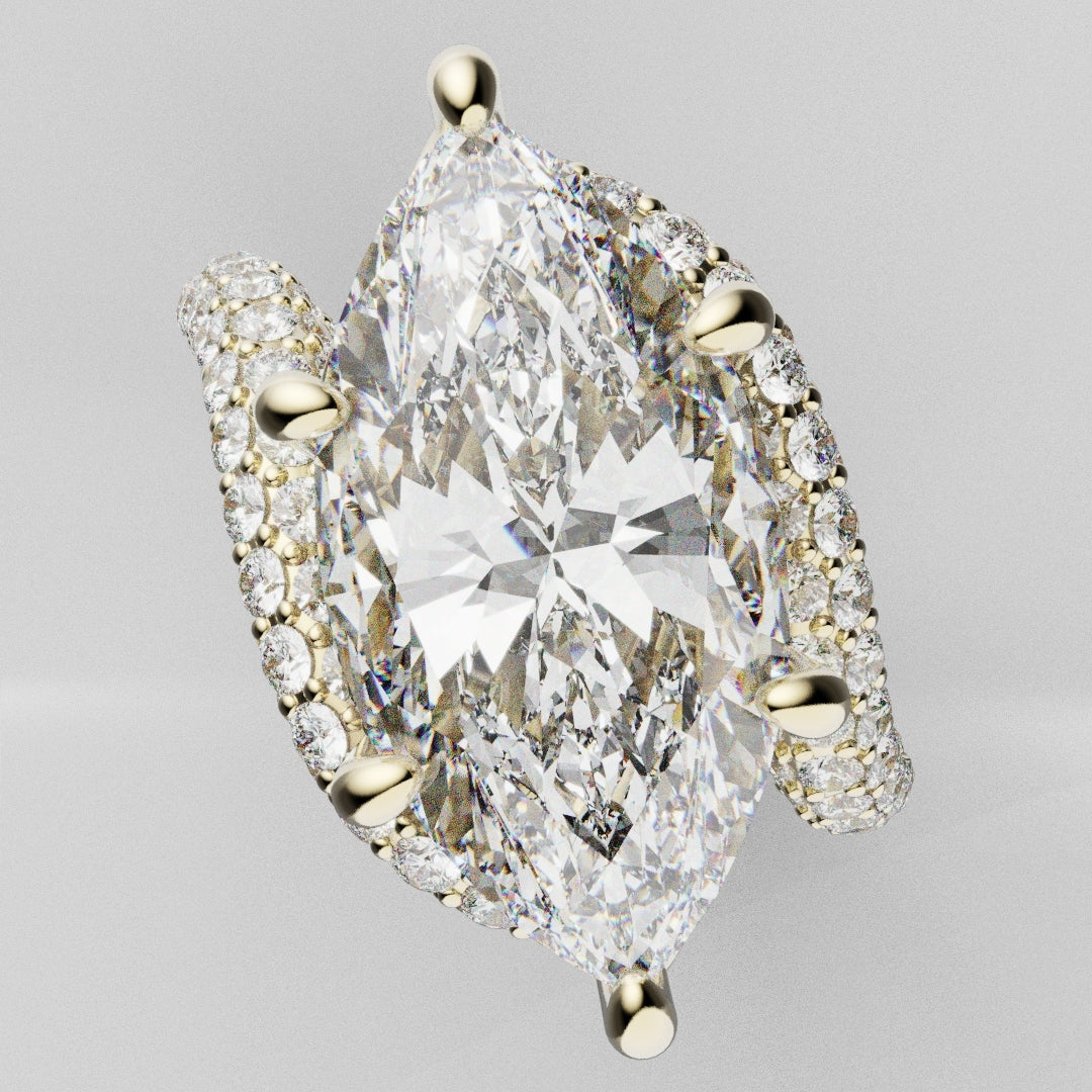 Elongated marquise-cut diamond ring showcasing exceptional brilliance with a pavé diamond band in 18ct yellow gold.