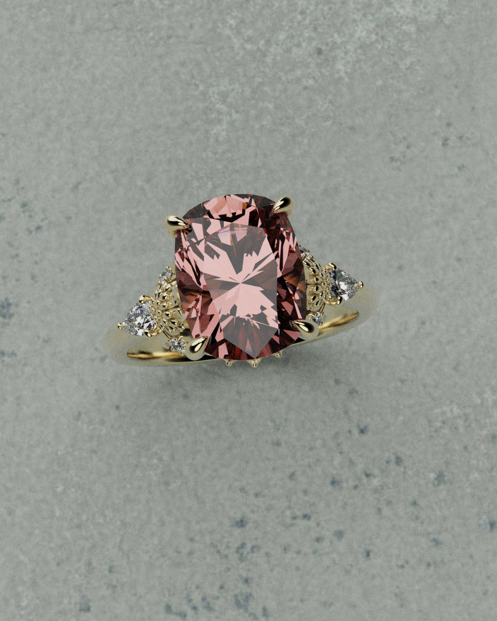 Ring with a padparascha sapphire and gold accents on a gray background