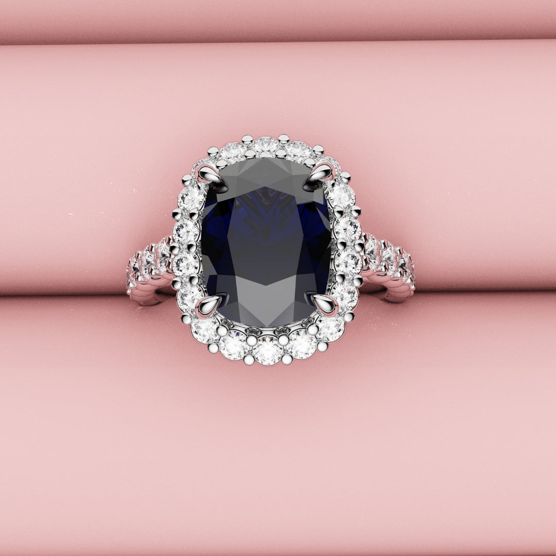 halo engagement ring with cushion cut blue sapphire center stone