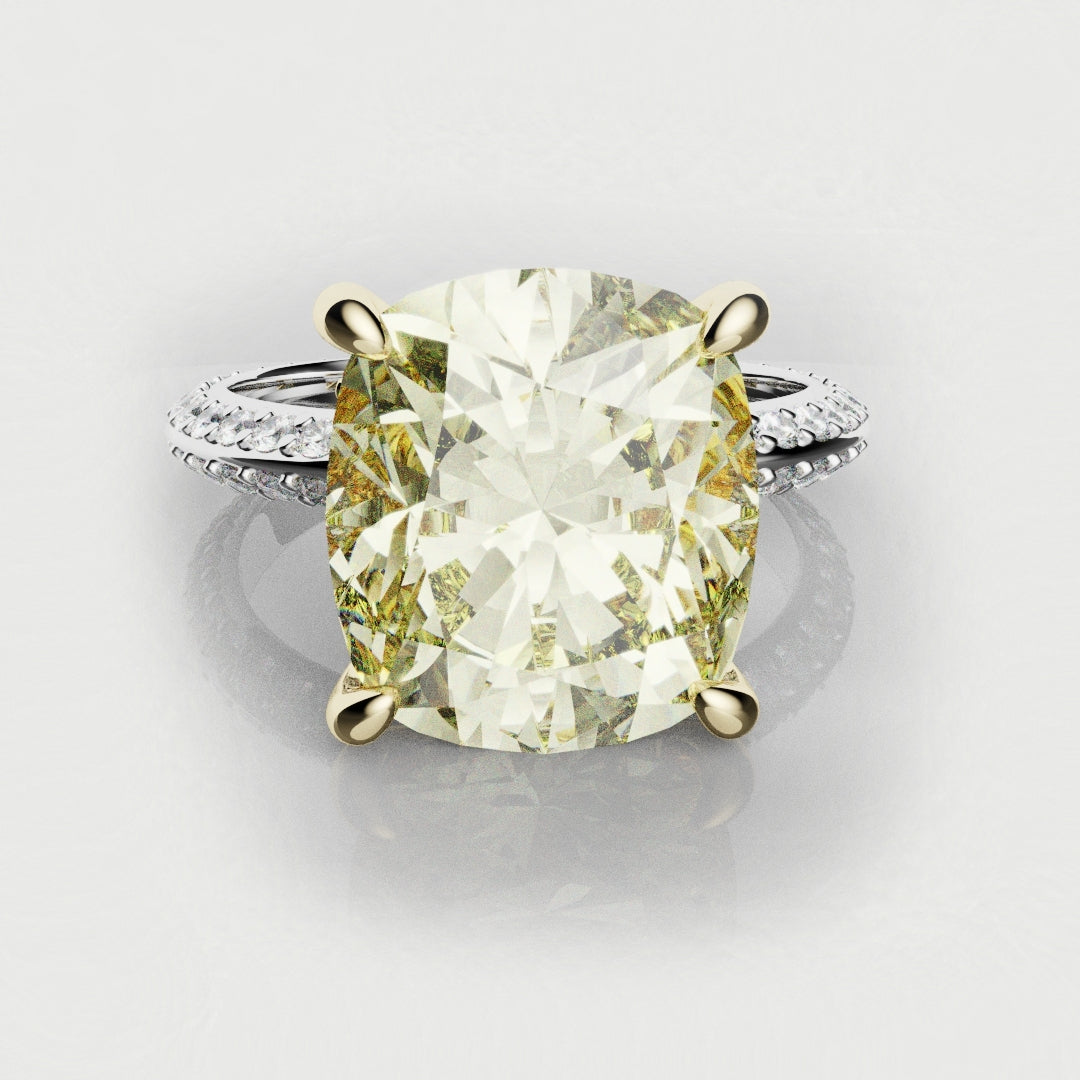Cushion cut yellow diamond engagement ring with unique hidden marquise detailing and a platinum pave band 