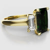 green emerald and baguette diamond trilogu ring