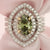 halo engagement ring with oval green diamond