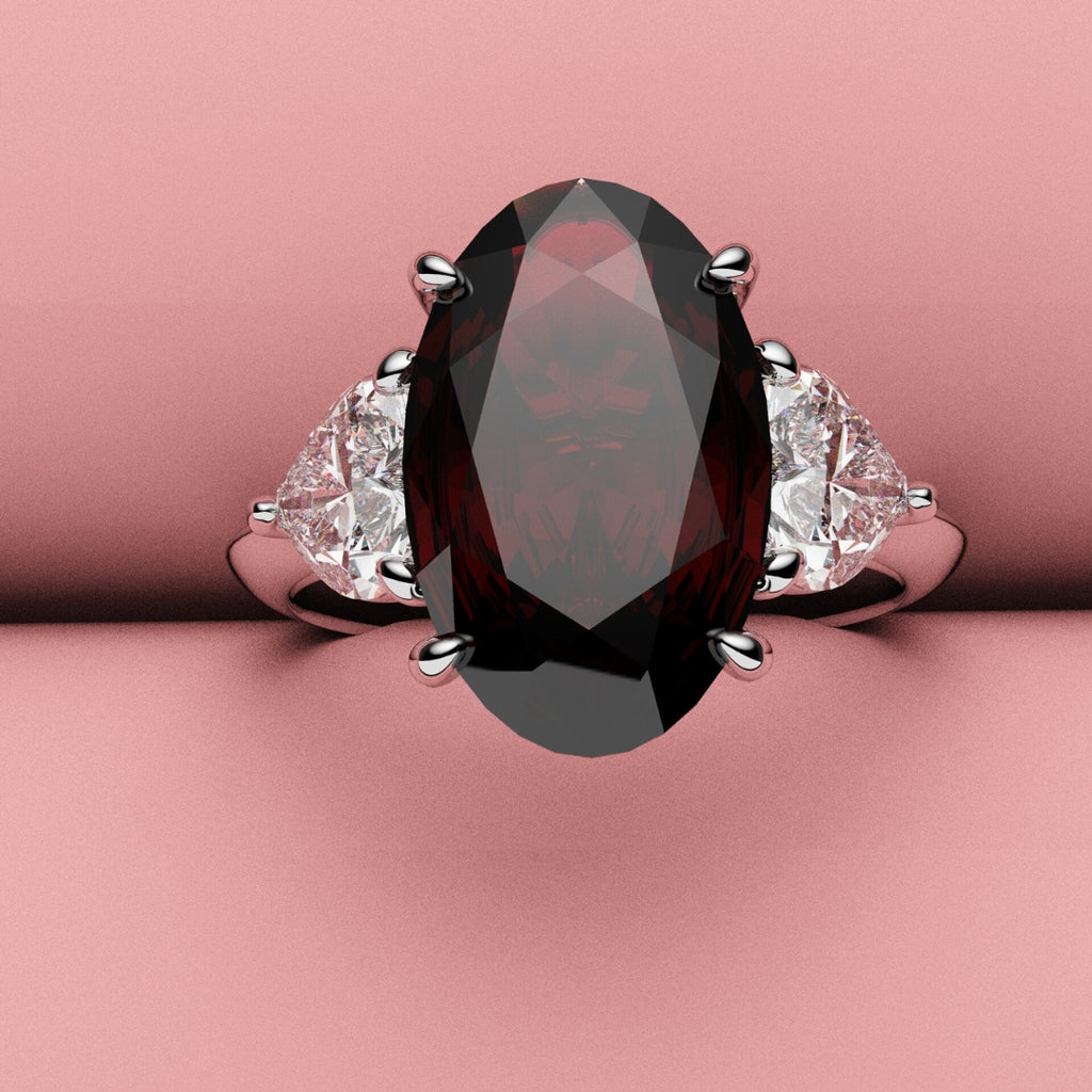 Oval ruby and heart diamond three stone ring 