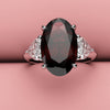 Oval ruby and heart diamond three stone ring 