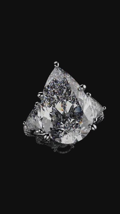 Platinum pear and trilliant diamond engagement ring with hidden halo detailing