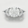three stone round and pear diamond engagement ring