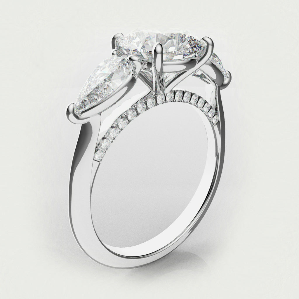 round and pear diamond three stone engagement ring