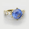 round cornflower blure sapphire engagement ring yellow gold band