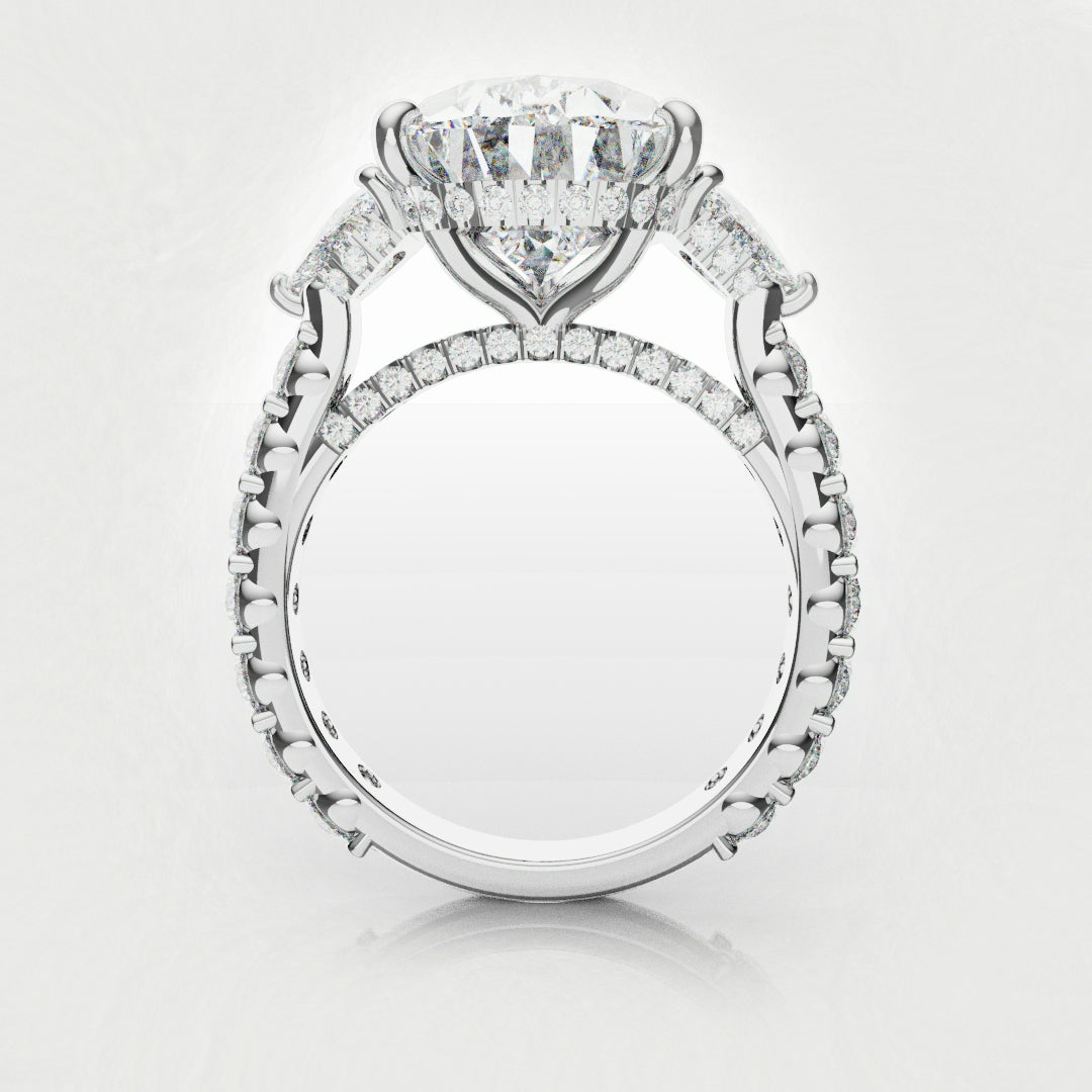 three stone engagement ring with pear and trilliant diamonds 